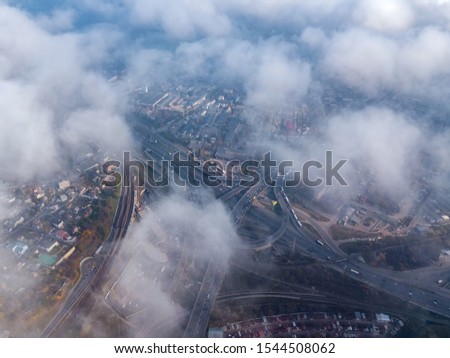 Aerial view. Kyiv city view thrue rare clouds.