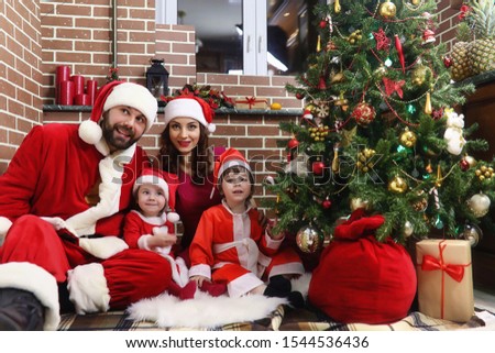 Santa Claus couple with kids Christmas tree