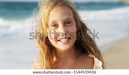 Adorable happy smiling little girl on beach vacation