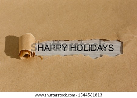 happy holidays text on paper. Word happy holidays on torn paper. Concept Image.