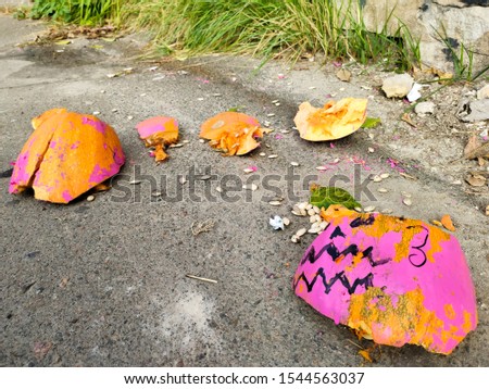 Halloween smashed pumpkin on asphalt. The end of Halloween