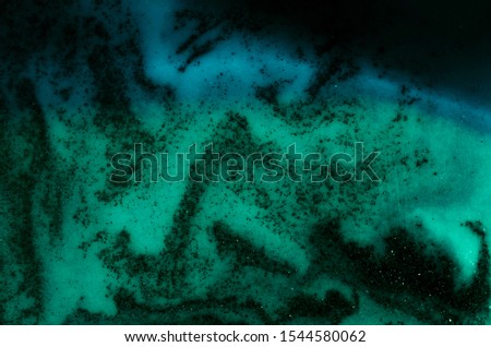 
The glitter sand abstract background texture blue-green gradient color similar to space or sky with stars.