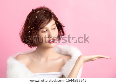 Beautiful asian woman isolated on pink background