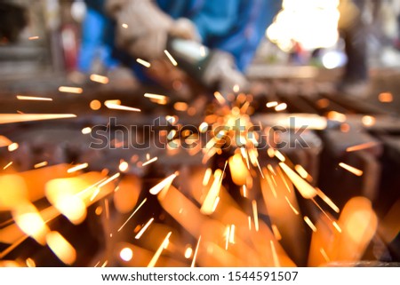Abstract and blur for background. sparkle light from grinding. Human grinding the metal with grinder.