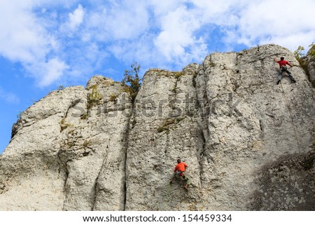 Rock climber climbing in Jura Plateau near Jerzmanowice village, Poland