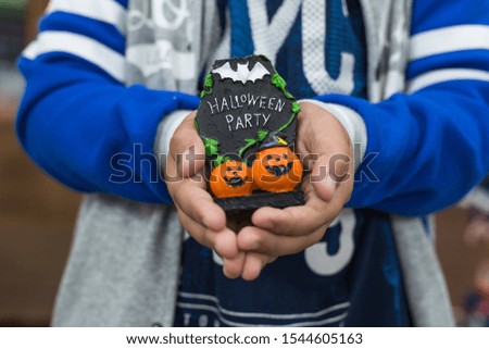 Halloween objects in the hands of a boy