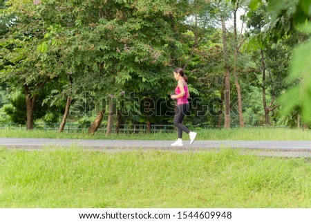 Fitness sport woman running on the path trail in the park in morning
