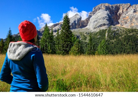 hiker girl in the mountains relaxing and enjoying the view