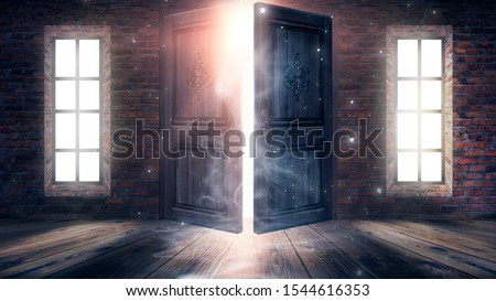 Dark room with large windows and open doors. Old brick walls, wooden floor. Sunlight shines through windows, rays, glare. Abstract room. Magical atmosphere.