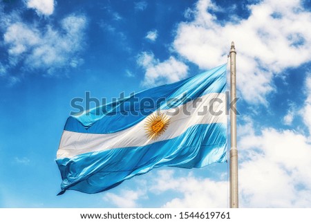 Flag of Argentina on a flagpole against a blue sky