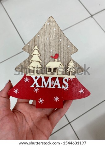 Fir tree wooden decoration in female hand