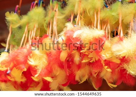 A lot of beautiful and bright decorative amulets dream catcher with feathers at the fair