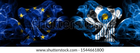 Eu, European union vs Commonwealth smoke flags placed side by side. Thick colored silky smokes abstract flags 