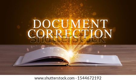 DOCUMENT CORRECTION inscription coming out from an open book, educational concept