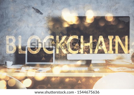 Multi exposure of blockchain theme hologram and table with computer background. Concept of bitcoin crypto currency.