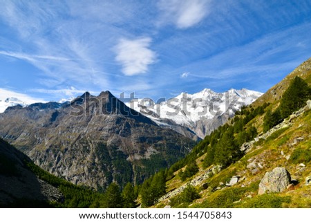 Idyllic landscape in the Alps with snow-capped mountain peaks.