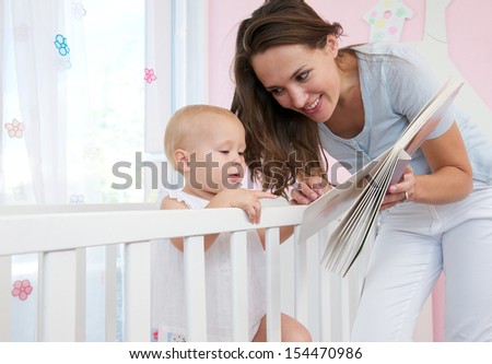 Closeup portrait of a mother and child reading a book together