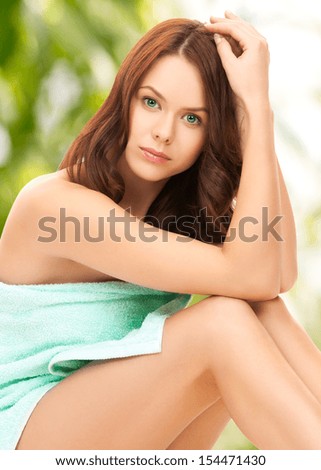 health, beauty, spa concept - picture of beautiful woman in towel