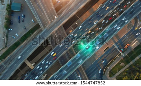 Beautiful aerial presentation of the autonomous cars self-driving concept on multi-level highway in Moscow. Direct view from above to the road traffic in a big city on the sunny evening.