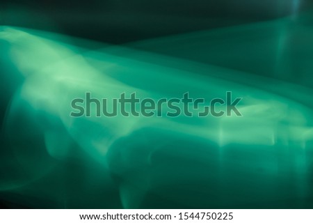 Colorful light traces with long exposure in the dark. abstract blurred lights background