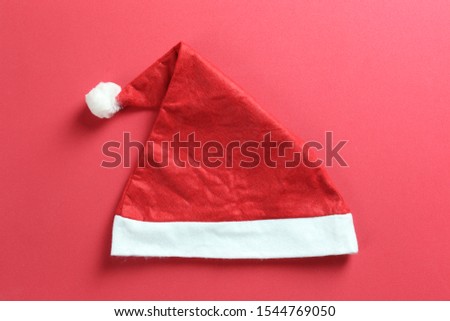 Santa hat on red art paper background for design in Christmas and New Year's concept.
