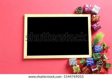 Christmas decoration and wooden frame on red art paper background and have copy space in Christmas and New Year concept.