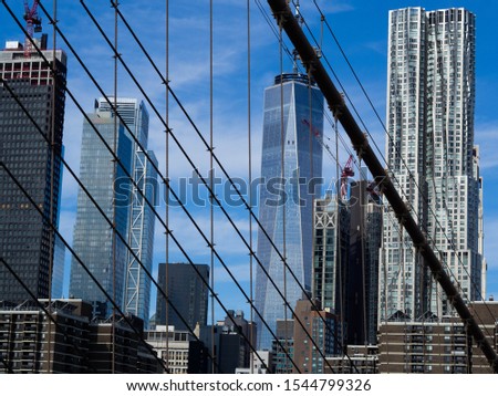 Detail of the buildings seen from the top of the Brooklyn Bridge on blue sky background. New York City, Manhattan.