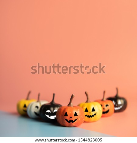 Halloween concept, Pumpkin with smile face on pastel colors background.