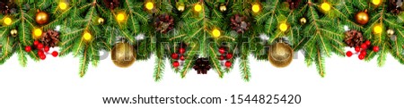 Amazing christmas border with fresh fir branches isolated on white. Golden balls, fir branches, cones, little light and red berries composition.