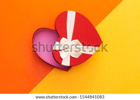 open heart shaped box on colorful background