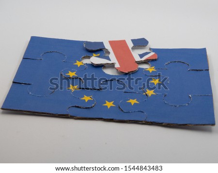 Jigsaw puzzle with picture of European flag with one piece showing part of the British flag in front of white background