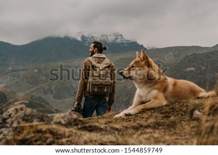 
man and dog in nature, 
photographer in the mountains, shiba inu, hachiko, 
japanese dog, 
puppy in nature, 
dog true friend