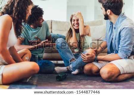 Multi-ethnical group playing "truth or dare" game and having fun. Royalty-Free Stock Photo #1544877446