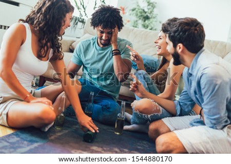Multi-ethnical group playing "truth or dare" game and having fun. Royalty-Free Stock Photo #1544880170
