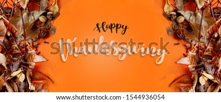 This is a picture from above on an orange background of leaves in Thanksgiving atmosphere with text that says happy holiday
