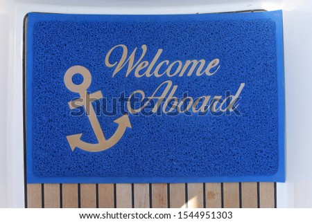 
blue rug with the words "welcome aboard" on the yacht