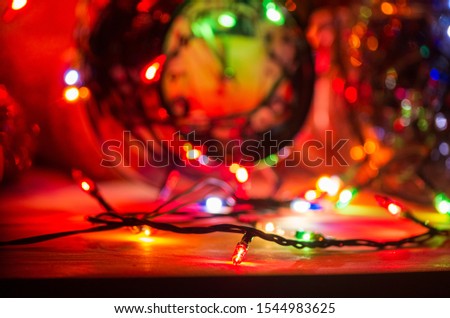 lights from a Christmas garland in a dark room, burning light bulbs, winter Christmas mood