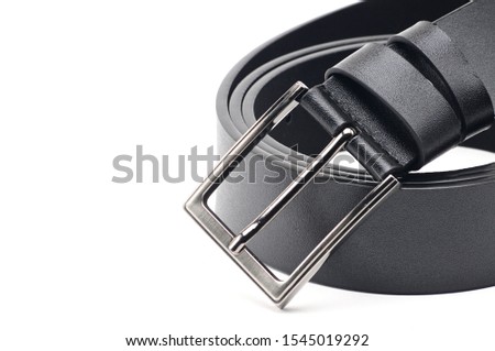 Black belt with a metal fastener on an isolated white background