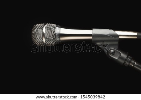 microphone on stand, black background
