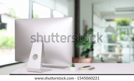 laptop monitor digital pc desk Workspace  Keyboard,blank screen coffee cup on a table in bright office room interior,Stylish workspace with desktop computer, office supplies, houseplant and books 
