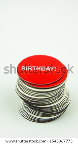 Red fridge magnet with text birthday on white background.