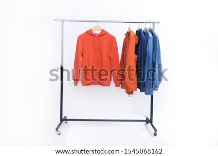 orange hoodie and orange fashion Wind jacket with jeans jacket with blue shirts on hanger

