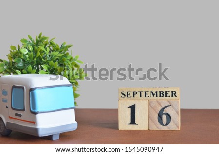 September cover design with number cube and car, Date 16.