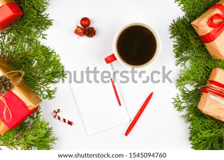 notebook with pen on christmas background. Empty white notebook and pen on white Christmas background of fir branches, cones, gifts. Letter To Santa Claus, mock up. Empty white notebook and pen on a