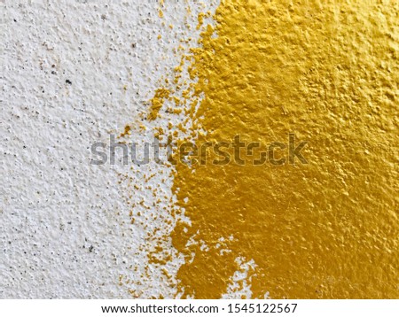 Gold or foil paint on wall concrete surface texture background