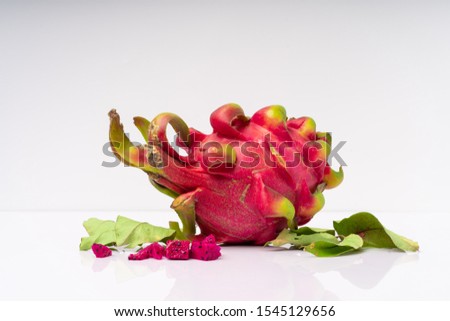 Multiple red dragon fruit in a pure white background