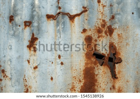 Old galvanized sheets with holes that rust.