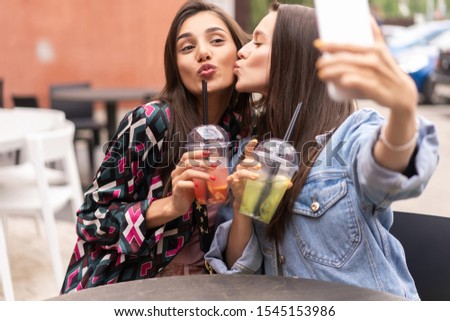Close up lifestyle selfie portrait of pretty fresh young brunette best friends girls making selfie, having fun.