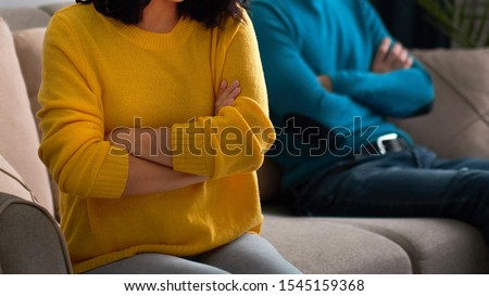 sad wife and husband, angry couple in bedroom. unhappy couple concept. usband and wife are sitting on the couch, looking away from each other. husband is not ready to have a dialogue Royalty-Free Stock Photo #1545159368
