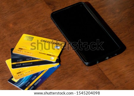 Close-up Of Business Paying With Credit Card On Mobile Phone.